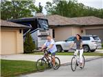 A couple riding bicycles at MOTORCOACH RESORT LAKE ERIE SHORES - thumbnail