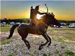 A statue of an Indian shooting an arrow from horseback at DINOSAUR VALLEY RV PARK - thumbnail