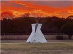 View larger image of A white teepee at dusk at DINOSAUR VALLEY RV PARK image #9