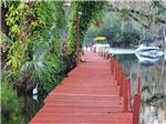 View larger image of A pier running alongside of the water at HAINES CREEK RV PARK image #1