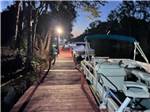 Tree lined boat dock at sunset at HAINES CREEK RV PARK - thumbnail