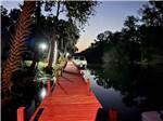 Tree lined wooden boat dock at HAINES CREEK RV PARK - thumbnail