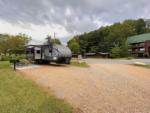 RV space with grill, fire pit, and table at APPALACHIAN SPRINGS OUTDOOR RESORT - thumbnail