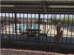 Looking at the pool thru the fence at HILLTOP RV PARK - thumbnail