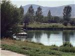 View larger image of The water with a fishing dock at DILLON MOTORCOACH  RV PARK image #9