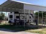 Covered parked trailer at site American Campground - thumbnail