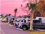 A row of trailers parked in RV sites at BAREFOOT RV RESORT - thumbnail