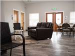 Sofas, tables and chairs set up in the lounge at COOL SUNSHINE RV PARK - thumbnail