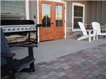 View larger image of Gas grill and lounge chairs set up outside of main building at COOL SUNSHINE RV PARK image #8