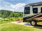 A motorhome in an RV site overlooking the water at TWIN CREEKS RV RESORT - thumbnail