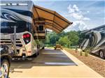 A motorhome in an paved RV site at TWIN CREEKS RV RESORT - thumbnail