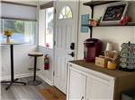 Room with table, stools and coffee machine at SUNNY OAKS RV PARK - thumbnail