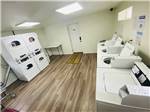 Laundry area with dryers and washing machines at SUNNY OAKS RV PARK - thumbnail