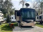 A motorhome parked in a gravel site at SUNNY OAKS RV PARK - thumbnail