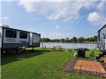 Grassy RV sites by the water at COOK'S LAKE RV RESORT & CAMPGROUND - thumbnail