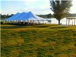 View larger image of A large event tent by the water at COOKS LAKE RV RESORT  CAMPGROUND image #6