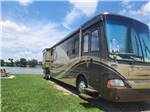 View larger image of A motorhome by the water at COOKS LAKE RV RESORT  CAMPGROUND image #7