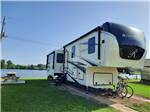 A fifth wheel trailer by the water at COOK'S LAKE RV RESORT & CAMPGROUND - thumbnail