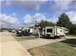 View larger image of A row of back in RV sites at CORRAL RV RESORT image #11
