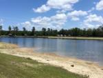 A view of the lake from the sandy shore at THOMPSON LAKE RV RESORT - thumbnail