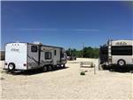 Two trailers parked in gravel sites at SUNDANCE RV PARK - thumbnail