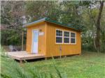 Cabin exterior view with deck at OUTPOST RV PARK & CAMPGROUND - thumbnail