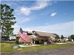 View larger image of Motorhome with American Flag in campsite at THE OAKS FAMILY CAMPGROUND image #2