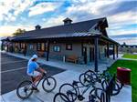 A biker near bike rack outside of campground building at CANYON VIEW RV RESORT - thumbnail
