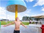 Camper enjoys water on a splash pad at CANYON VIEW RV RESORT - thumbnail