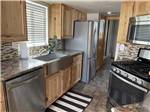 Kitchen area of White River Casita tiny home model at TRAIL & HITCH RV PARK AND TINY HOME HOTEL - thumbnail