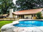 Pool area with view of the lodge at FOREST LAKE RV PARK & EVENTS - thumbnail