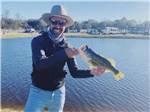 A man holding a fish he caught at ERIC & JAY'S RV RESORT - thumbnail