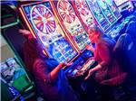 View larger image of Two people playing video slots at 12 TRIBES LAKE CHELAN CASINO  RV PARK image #7