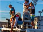 A family on a boat fishing nearby at ANTELOPE POINT MARINA RV PARK - thumbnail