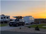 A car and a small trailer parked at sunset at ANTELOPE POINT MARINA RV PARK - thumbnail