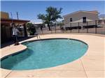 View larger image of A man cleaning the swimming pool at PALO VERDE ESTATES image #2