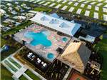 View larger image of An aerial view of the clubhouse and pool at CHAMPIONS RUN LUXURY RV RESORT image #3