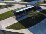 Aerial view of a Class A motorhome in a paved site at ORANGE LAKE RV RESORT - thumbnail