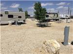 View larger image of An empty gravel RV site at BONNIE  CLYDES GETAWAY RV PARK image #2