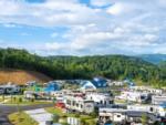 View of RV sites and tree covered hill at Camp Margaritaville RV Resort & Lodge - thumbnail