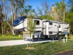 5th wheel parked on a paved site at PIGEON FORGE LANDING RV RESORT - thumbnail