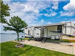 A trailer in a RV site overlooking the water at FOUR CORNERS RV RESORT - thumbnail