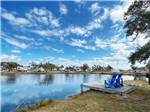 View larger image of A dock with chairs overlooking the water at QUILLYS BIG FISH RV PARK image #1