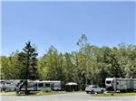Towable RVs parked onsite with trees in background at WEST BAY ACADIA RV CAMPGROUND - thumbnail