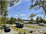 Parked RVs in gravel sites at WEST BAY ACADIA RV CAMPGROUND - thumbnail
