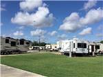 A grassy area next to a group of RV sites at BEAUMONT RV & MARINA - thumbnail