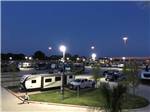 A truck and travel trailer parked in a site at night at LAKESHORE RV RESORT - thumbnail
