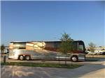 View larger image of A large motorhome in a paved pull thru RV site at LAKESHORE RV RESORT image #11