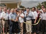 View larger image of The owners cutting a yellow ribbon at PARKSIDE RV PARK image #7