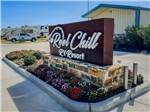 View larger image of Front entrance with sign and office building at REEL CHILL RV RESORT image #2